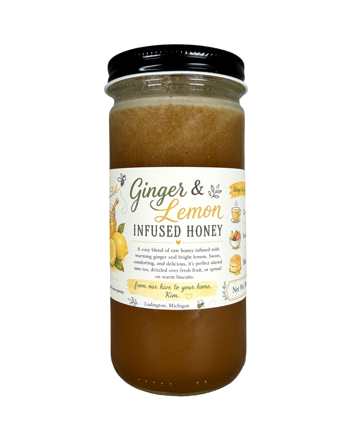 A glass jar of Ginger & Lemon Infused Honey with a black lid and a white label featuring yellow lemons and green text, set against a plain white background.