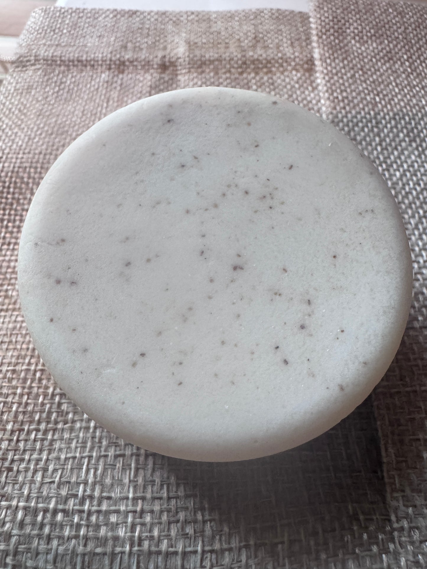 close up goat milk soap with loofah
