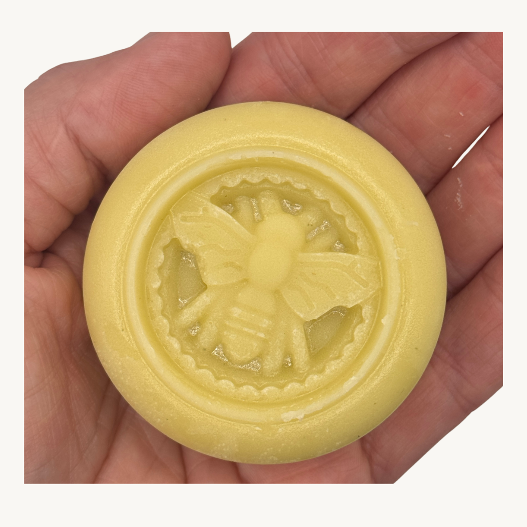 Image of hand holding beeswax lotion bar