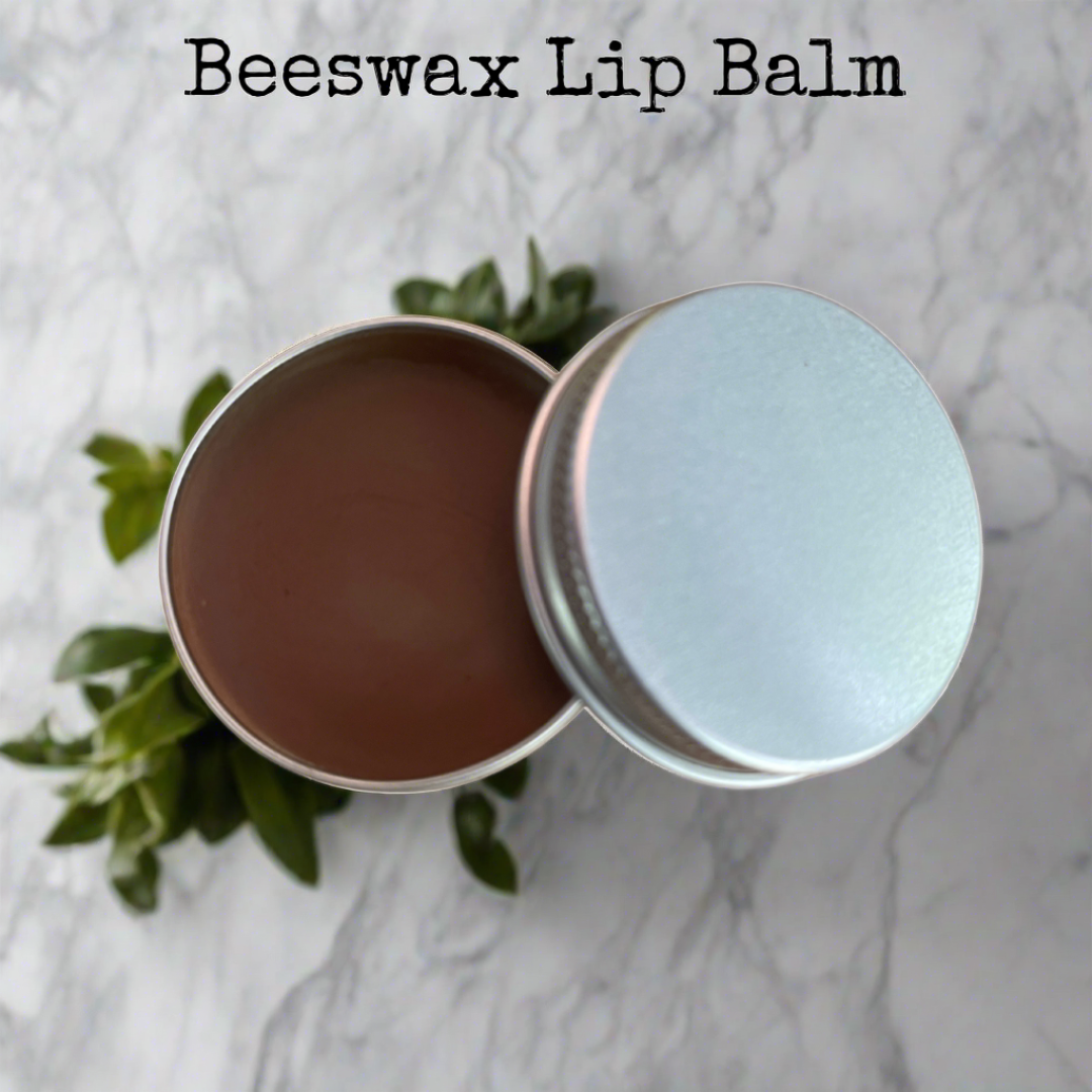 Handmade beeswax lip balm in a reusable tin, crafted with natural ingredients including herb-infused oil, castor oil, and pure beeswax for deep hydration and nourishment.