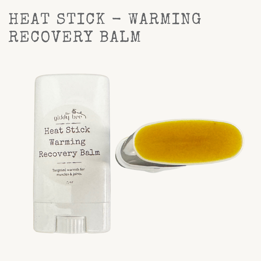 Heat Stick warming recovery balm in a push-up tube made with beeswax and botanical oils for sore muscles and stiff joints