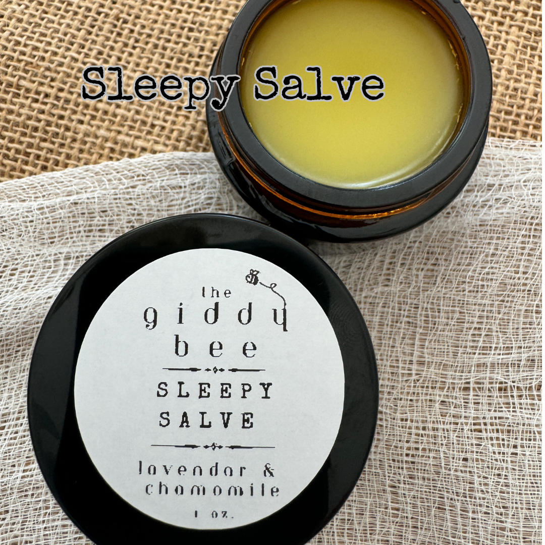 A handcrafted jar of Sleepy Salve, made with lavender and chamomile-infused oils, beeswax, and shea butter, presented in small-batch packaging by an award-winning South Carolina beekeeper and gardener.